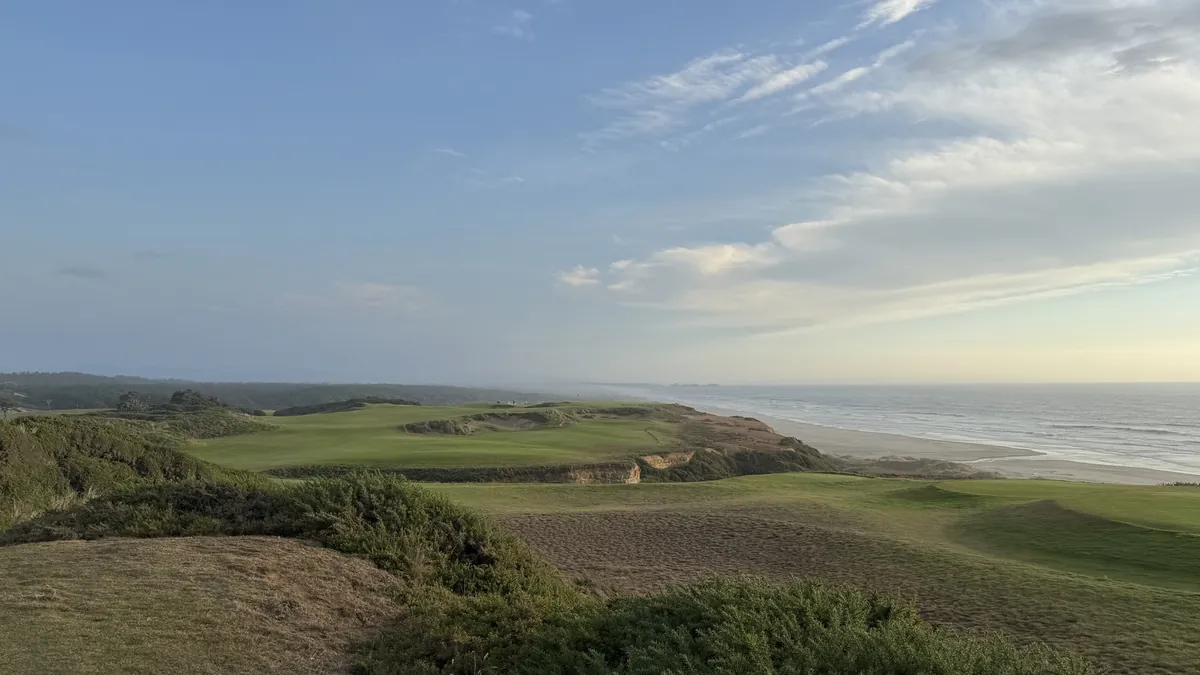 A coastal golf course stretching along cliffs above the ocean.